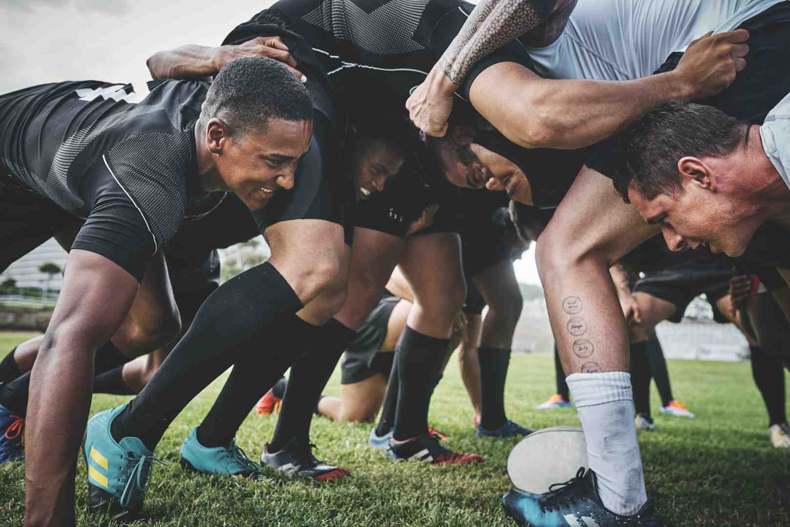 RUGBY team playing on the pitch in heat, sweating intensely