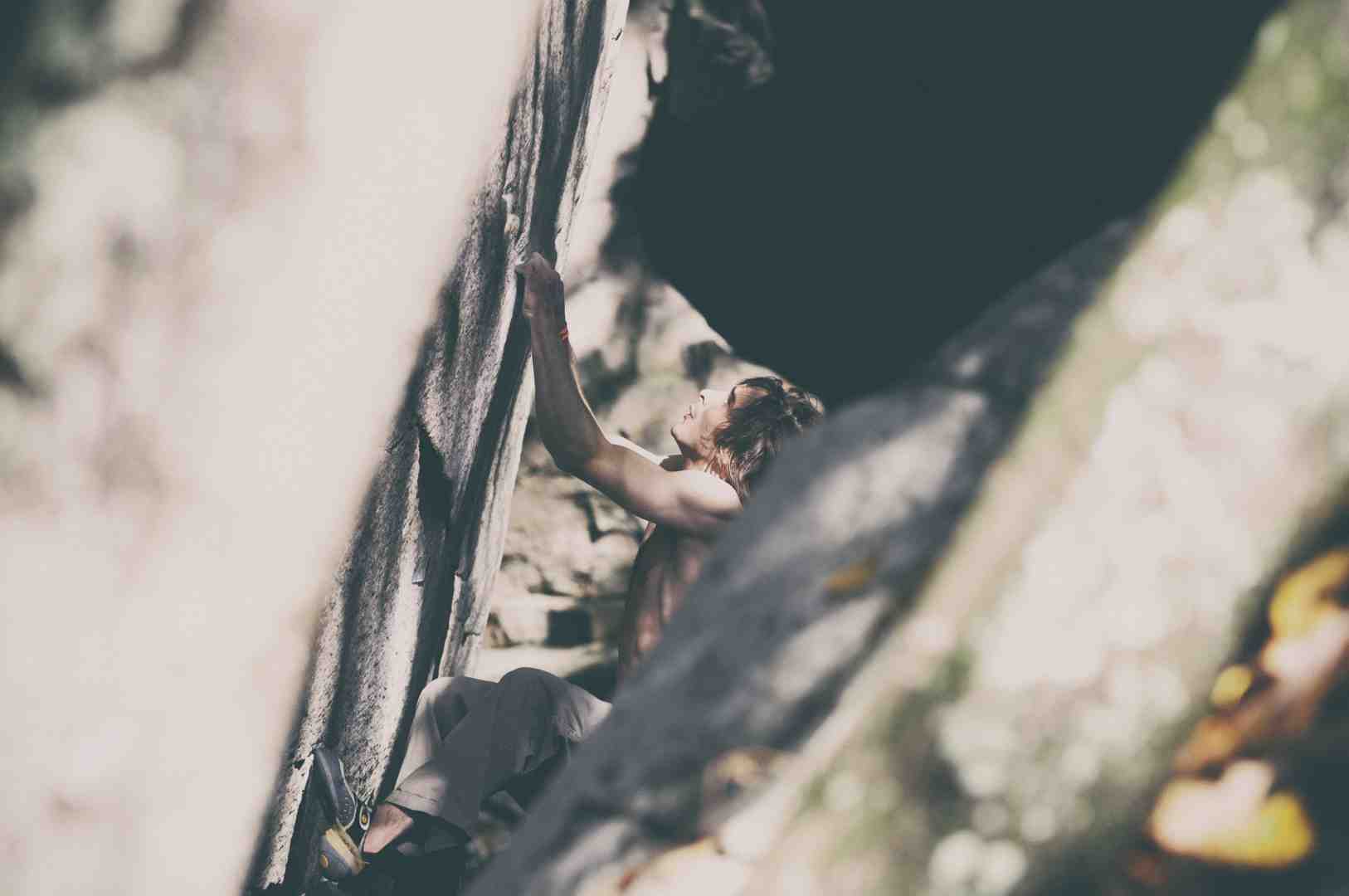 climber ascending through a narrow crevice climber ascending through a narrow crevice