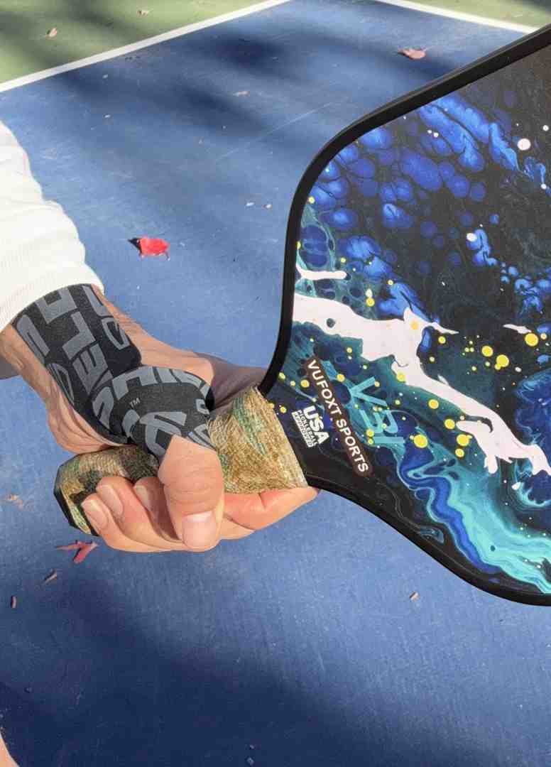 Player demonstrating a proper supportive wrist taping technique, which can be combined with stretching for safety and prevention of injuries