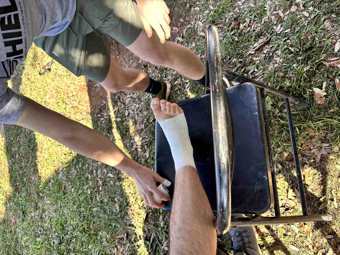 athletic trainer applying tape to ankle - athletic tape for football players athletic trainer applying tape to ankle - athletic tape for football players