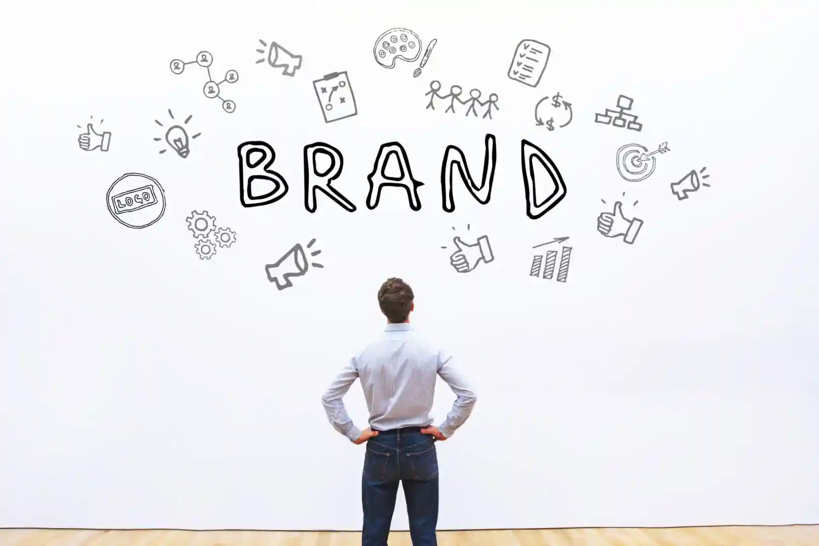 A person pointing at a whiteboard with brand strategy elements written on it - brand strategy definition