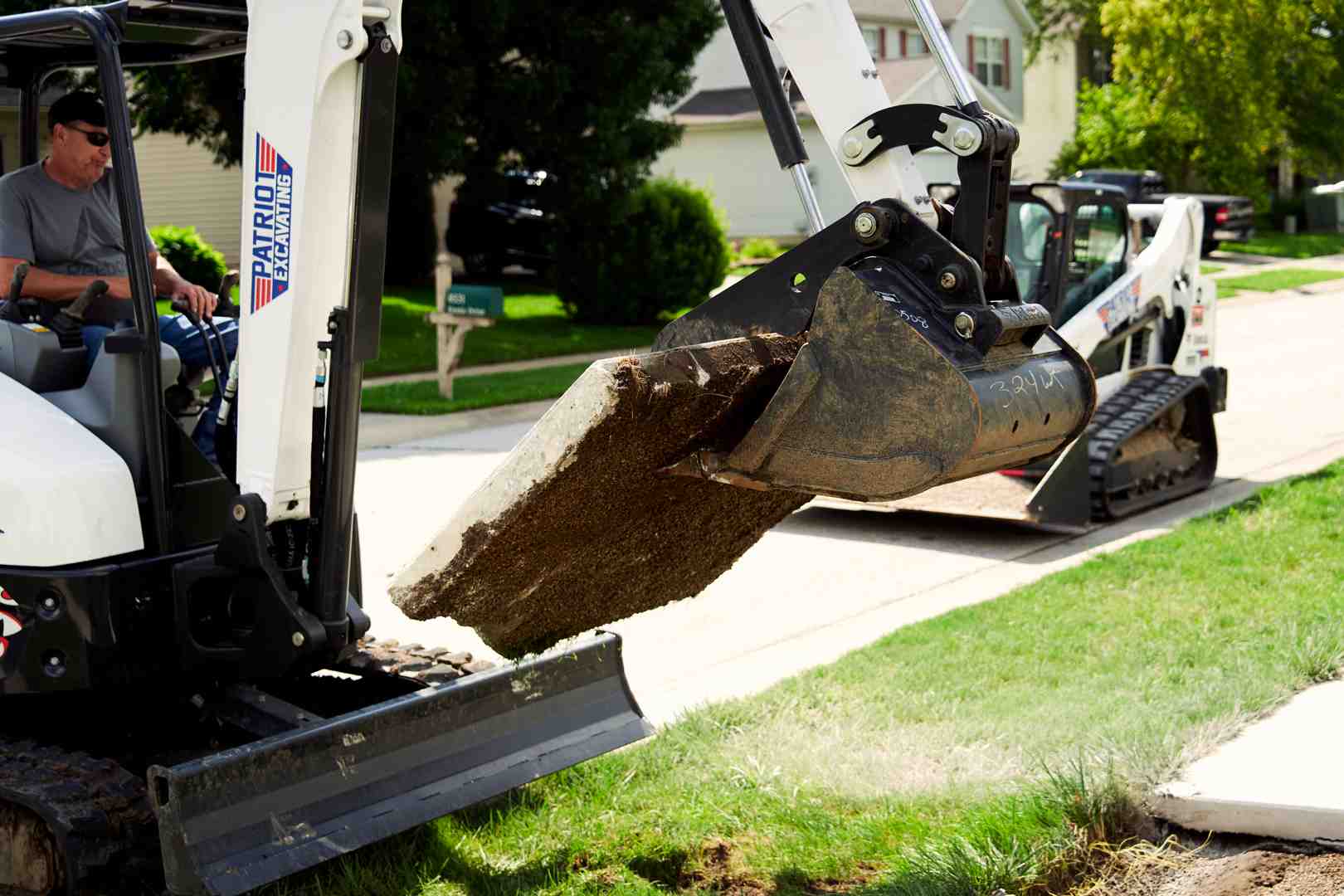 of a mini-excavator with a hydraulic breaker attachment working on a patio - remove concrete patio of a mini-excavator with a hydraulic breaker attachment working on a patio - remove concrete patio