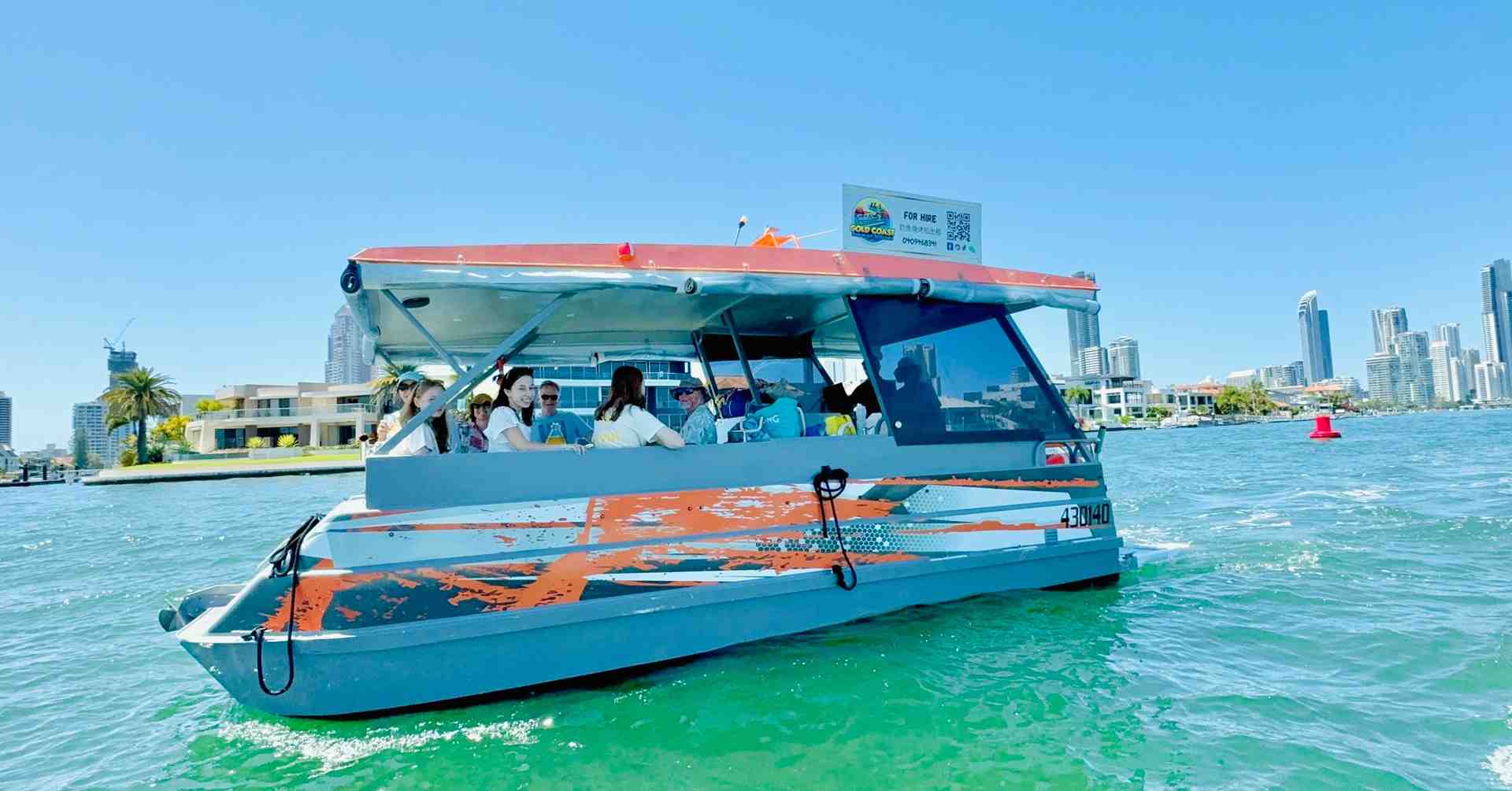 Group of people enjoying a sunny day on a BBQ pontoon boat cruising with the Gold Coast skyline in the background - Gold Coast BBQ boat Group of people enjoying a sunny day on a BBQ pontoon boat cruising with the Gold Coast skyline in the background - Gold Coast BBQ boat