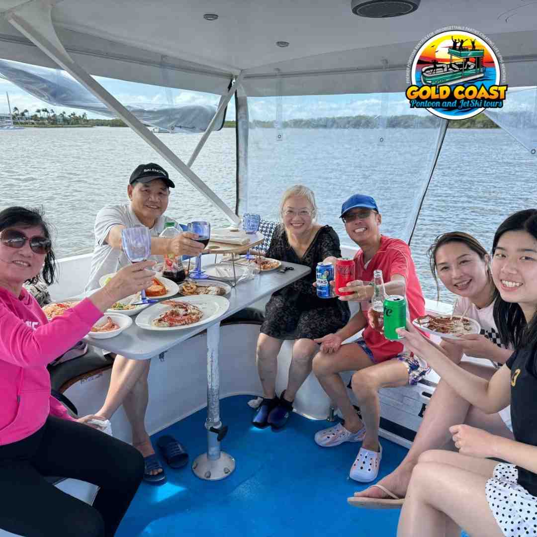 Family and friends toasting while enjoying a meal on a BBQ Pontoon boat with Gold Coast Pontoon and Jet Ski Tours - Pontoon Christmas parties