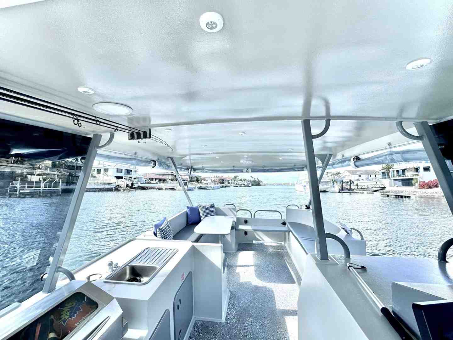 The spacious and comfortable onboard BBQ and seating area of a GC Jet Ski pontoon boat, ready for a party. - Full day vs half day pontoon hire The spacious and comfortable onboard BBQ and seating area of a GC Jet Ski pontoon boat, ready for a party. - Full day vs half day pontoon hire