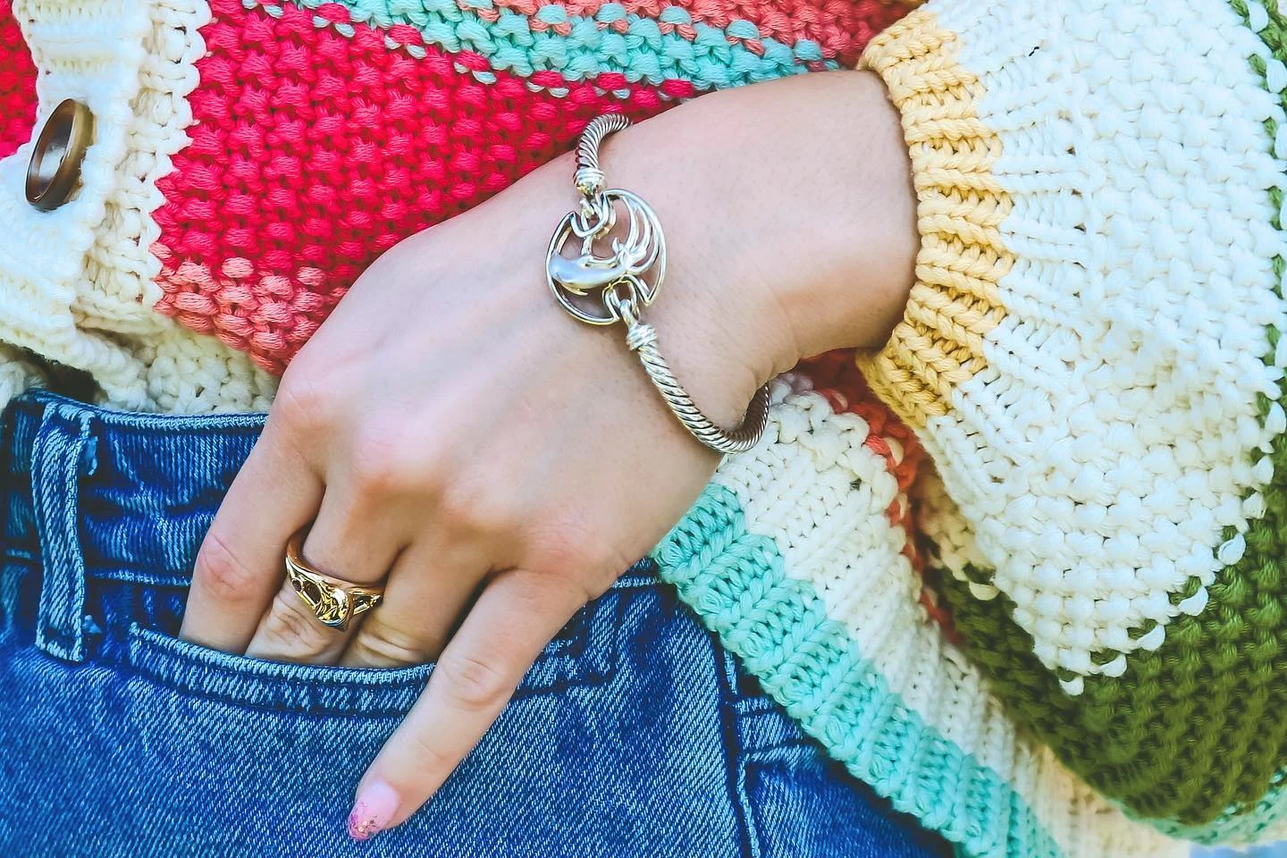 Layered silver jewelry styling with rings and bracelet