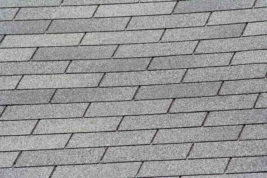 Close-up view showing the flat, repeating pattern of installed 3-tab shingles - 3 tab composition shingle Close-up view showing the flat, repeating pattern of installed 3-tab shingles - 3 tab composition shingle