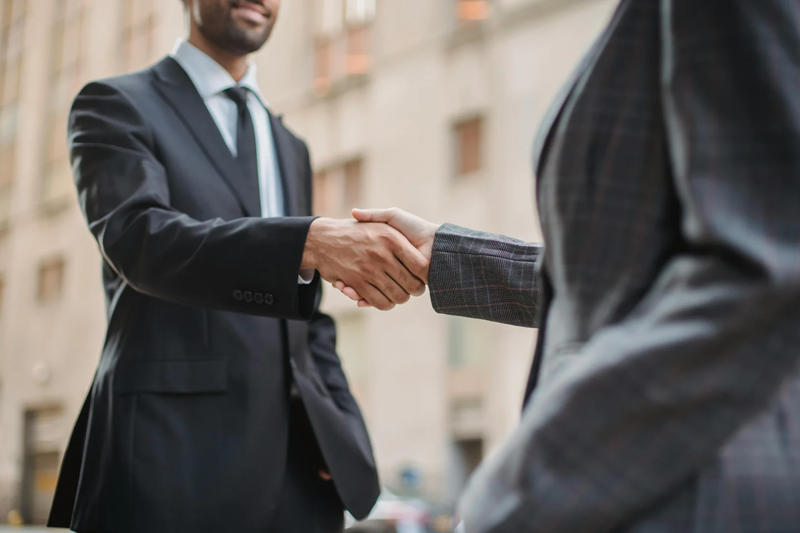 Government agency handshake symbolizing partnership and successful CRM implementation.