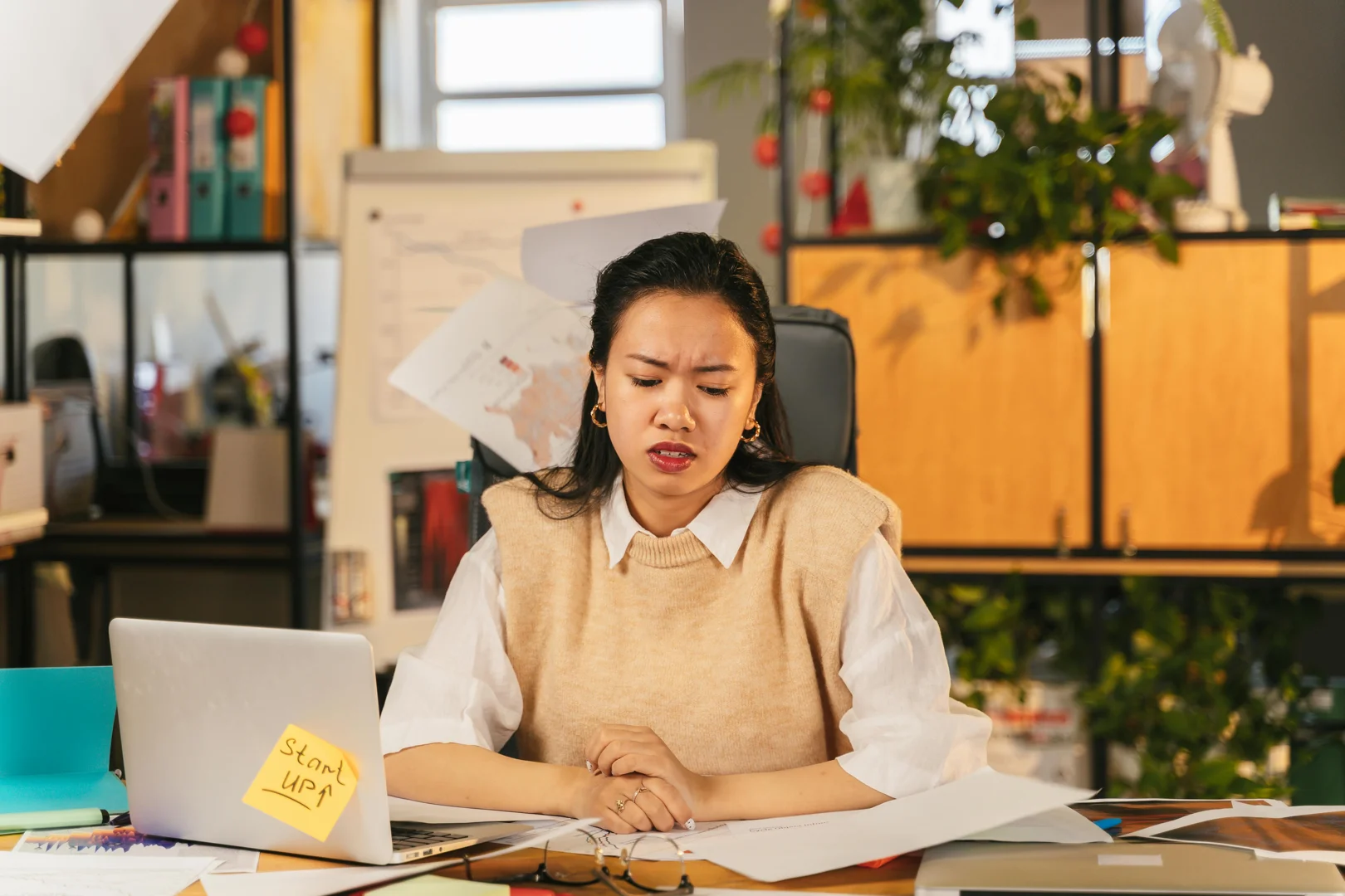 Stressed businesswoman reviewing CRM implementation for membership organisations.