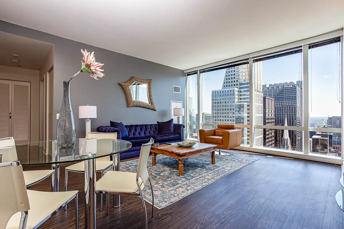 Modern living room with floor-to-ceiling windows overlooking the city - chicago corporate housing short term