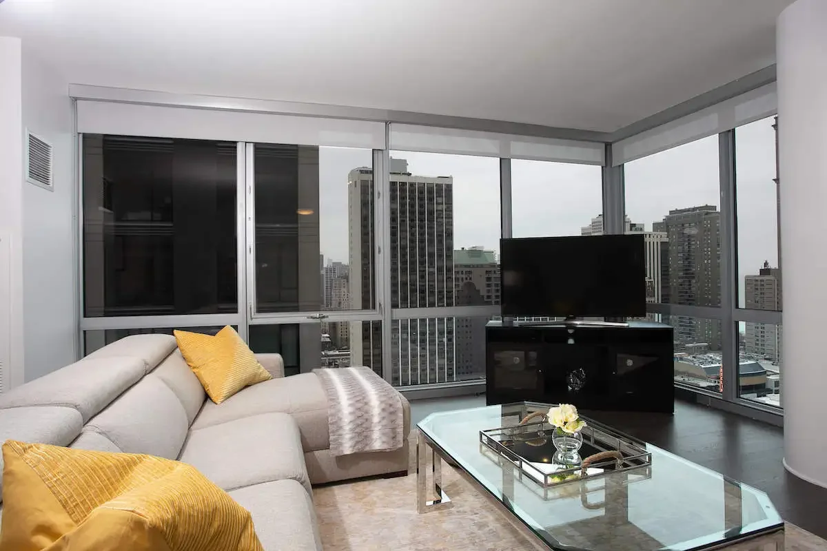 luxurious fully furnished living room in Chicago Gold Coast with floor to ceiling windows and modern decor - gold coast short term rentals luxurious fully furnished living room in Chicago Gold Coast with floor to ceiling windows and modern decor - gold coast short term rentals
