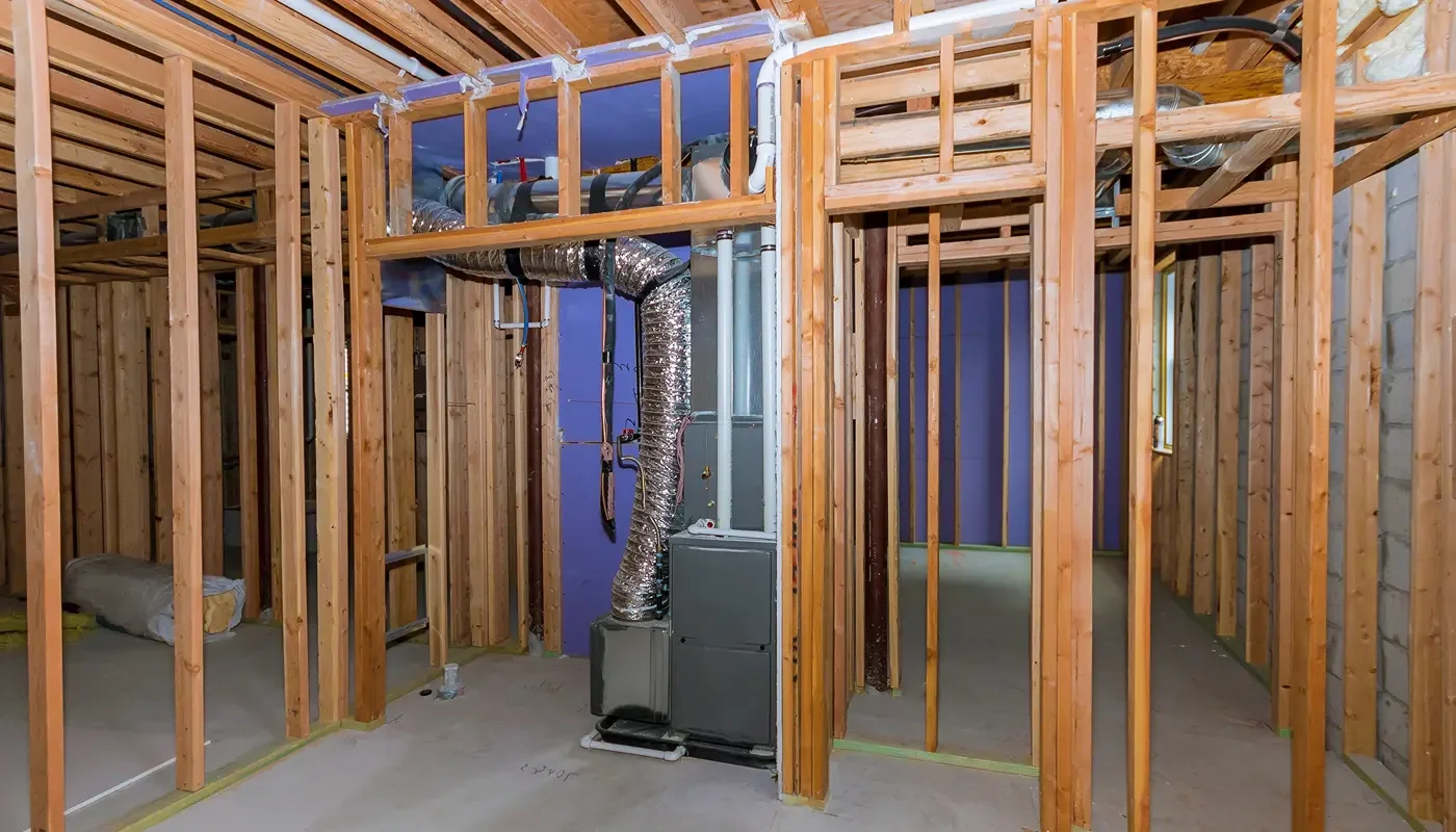 Homeowner replacing a gray, dirty air filter - furnace blowing cold air