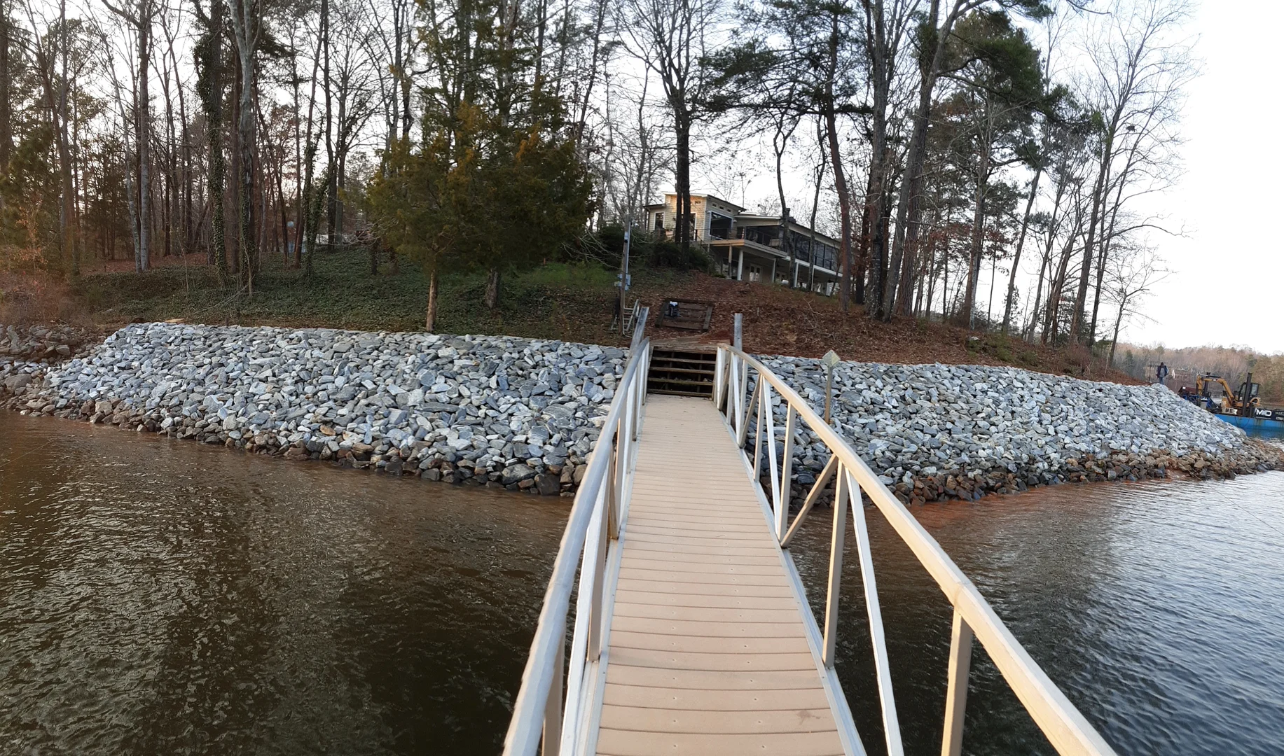 Riprap revetment on a lake shoreline showing proper slope and alignment - riprap design