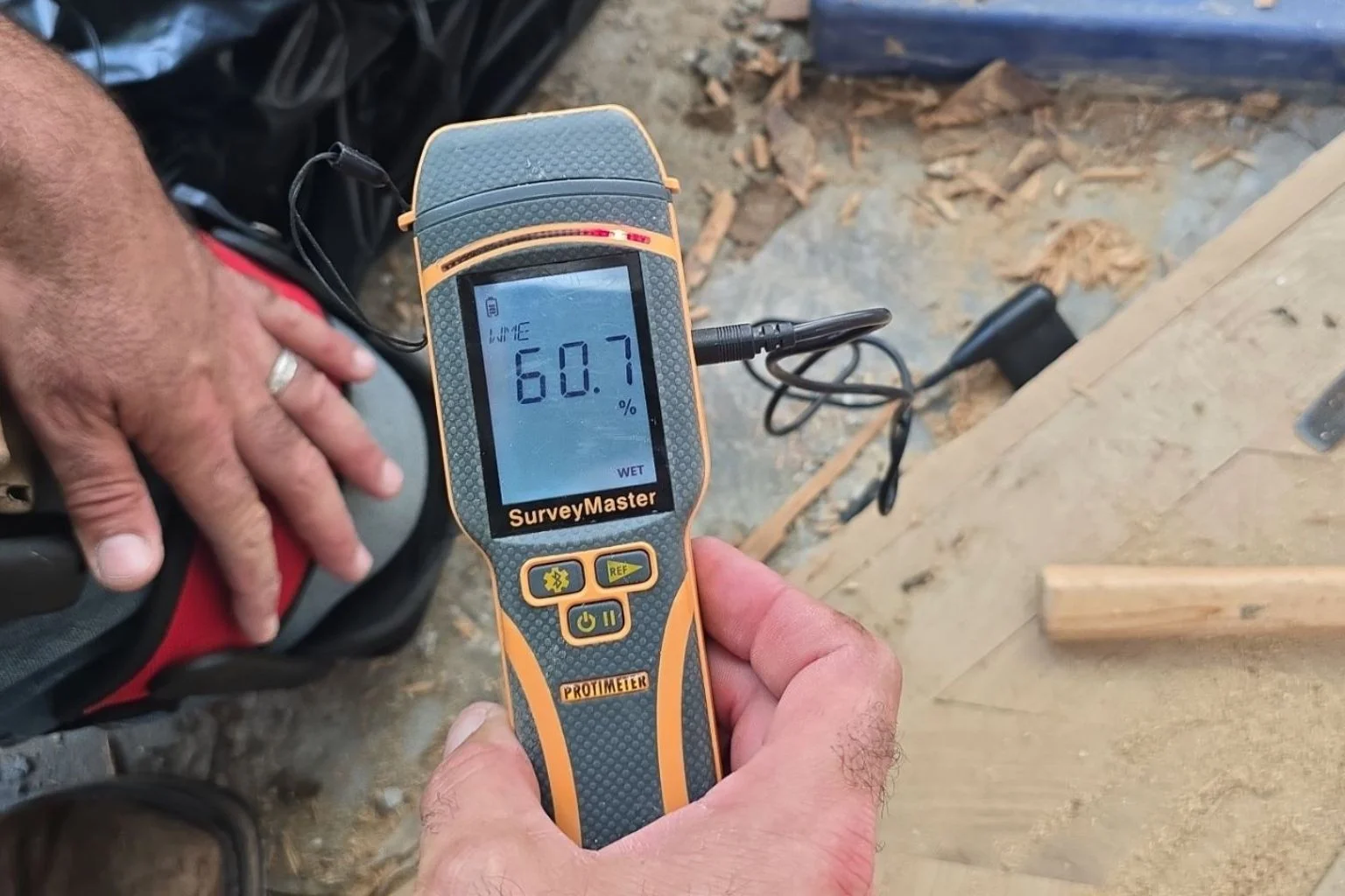 Floorboard water damage inspection for Florida insurance claim documentation.