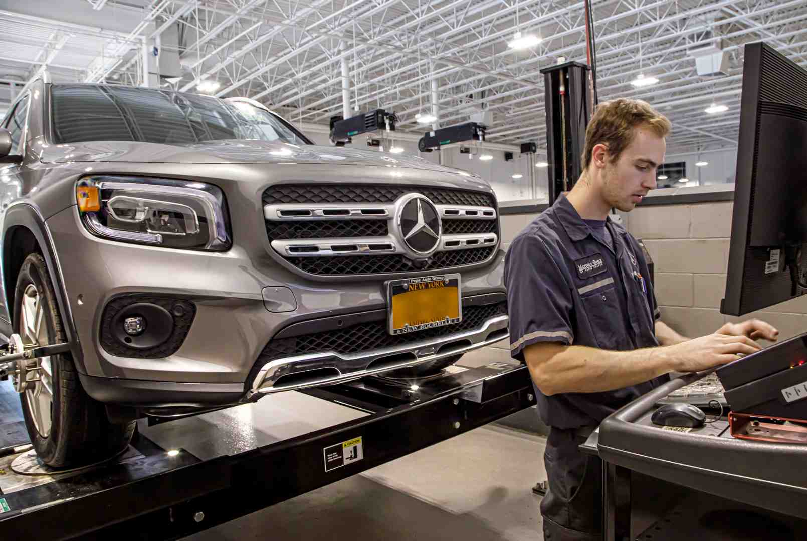 Mercedes-Benz technician running diagnostics on a Mercedes-Benz SUV illustrating Benzel-Busch service Mercedes-Benz technician running diagnostics on a Mercedes-Benz SUV illustrating Benzel-Busch service