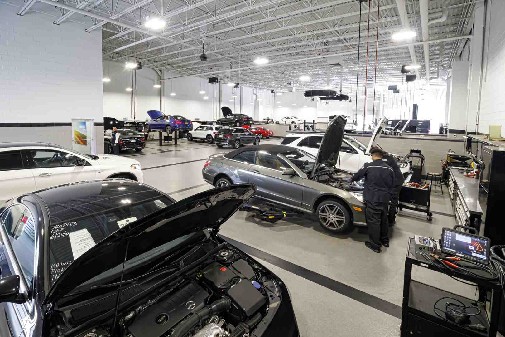 Benzel-Busch technician carefully inspecting a Mercedes-Benz or Genesis engine bay - Benefits of CPO Benzel-Busch technician carefully inspecting a Mercedes-Benz or Genesis engine bay - Benefits of CPO