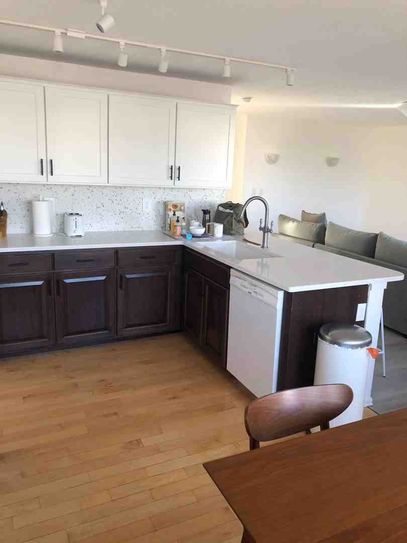 professional installer leveling base cabinets with shims - countertop installation