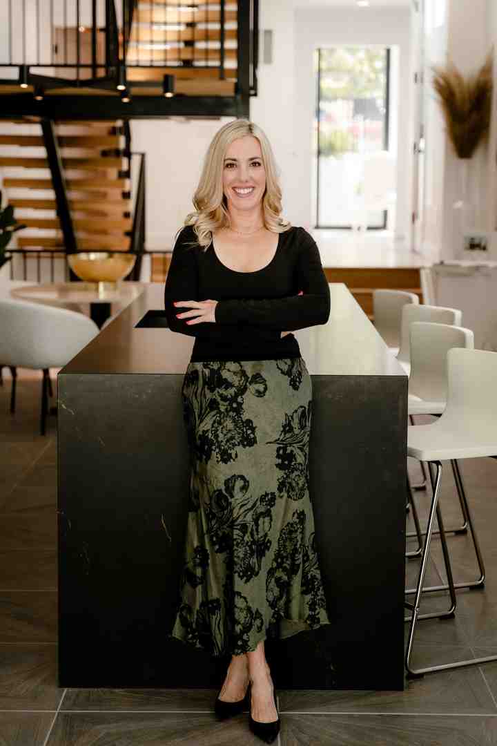 A smiling couple or family in front of a Sold sign in a Denver neighborhood. - Sell home fast Denver