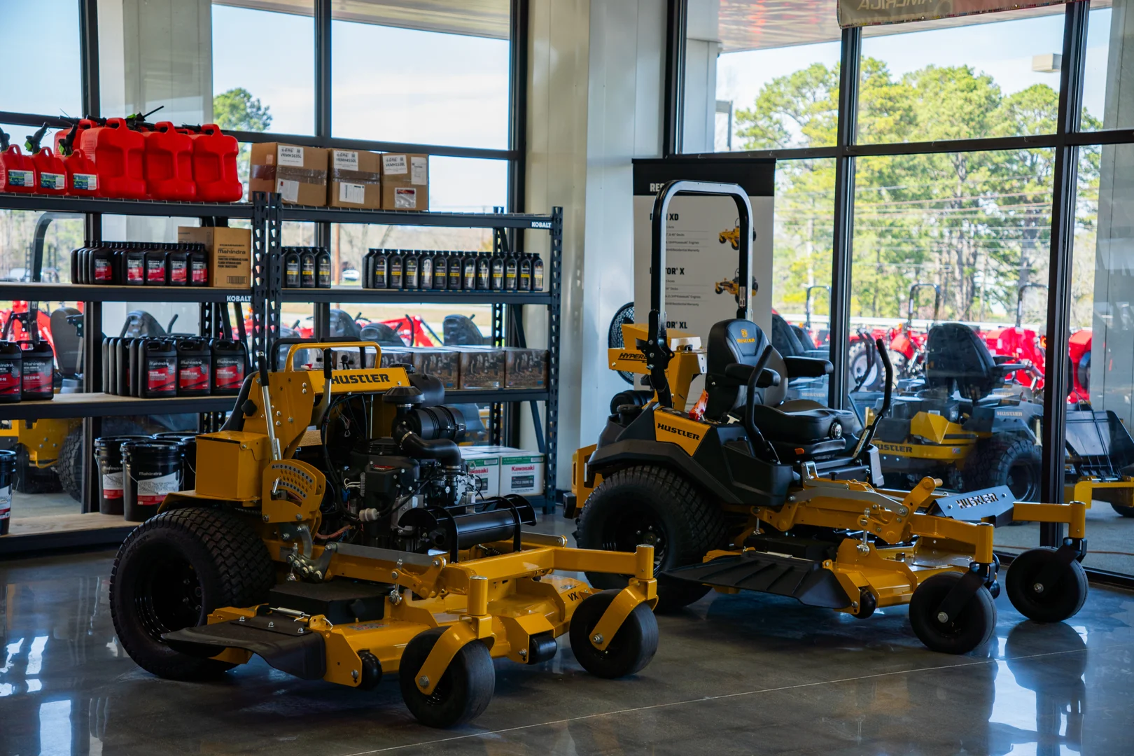 Organized service bay with Hustler zero turn mower on maintenance lift Organized service bay with Hustler zero turn mower on maintenance lift