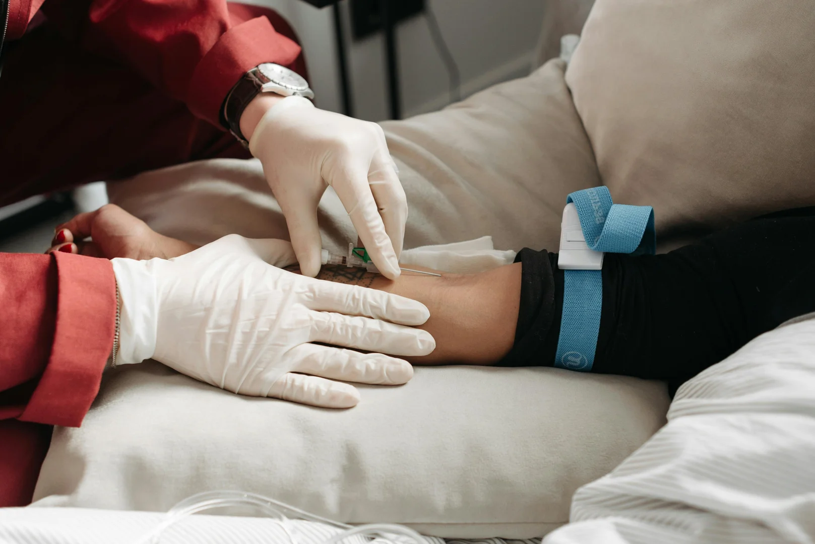 A physician inserting a needle for medical detox purposes 