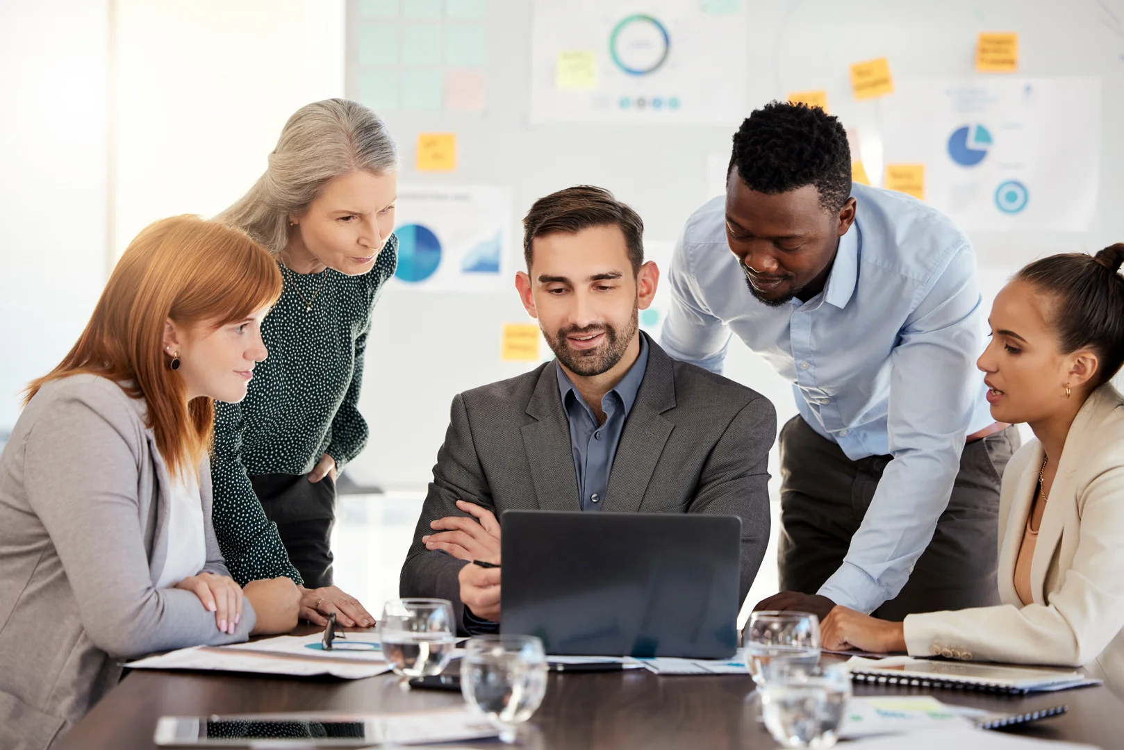 A team of consultants conducting a strategy session with a CEO - business management consultant A team of consultants conducting a strategy session with a CEO - business management consultant