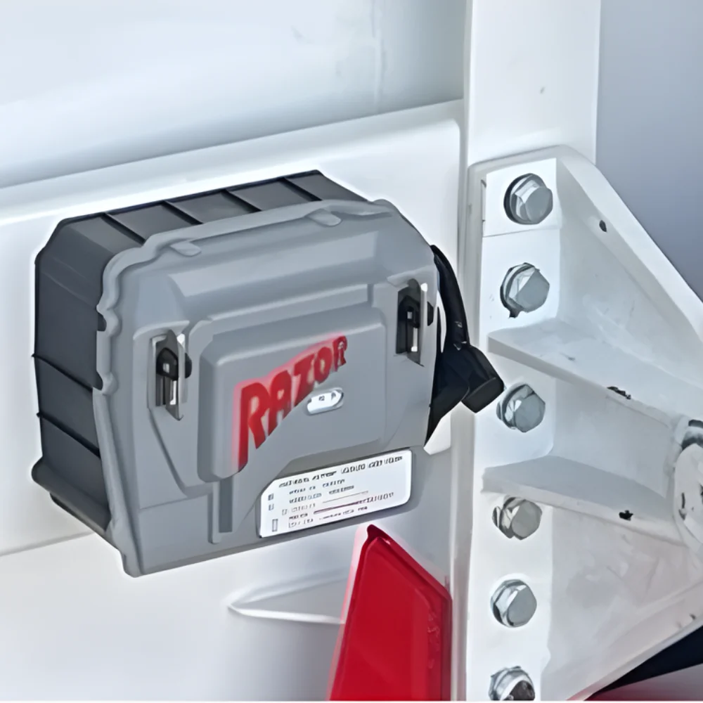 Precision control hardware for automatic retractable truck tarps, featuring a durable electronic motor mounted to a heavy-duty trailer.