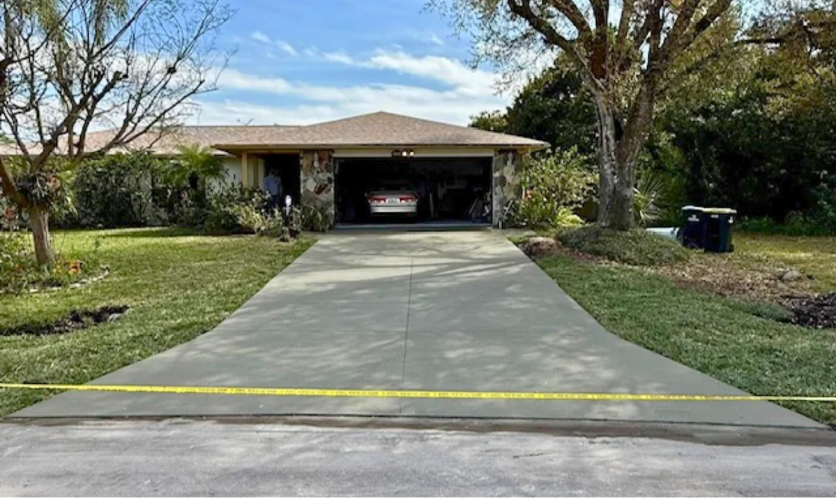 Before and after old cracked driveway replaced with new concrete driveway in Melbourne FL
