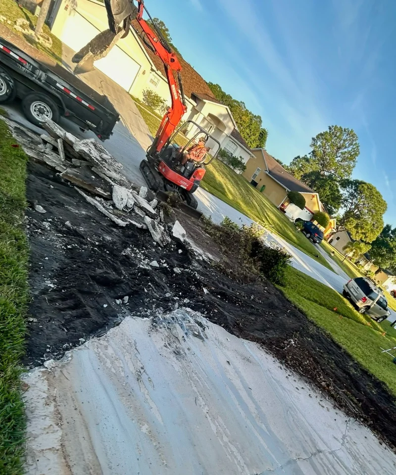 Professional JCD Concrete crew grading a driveway site in Palm Bay FL - 5000 PSI concrete driveway Brevard County