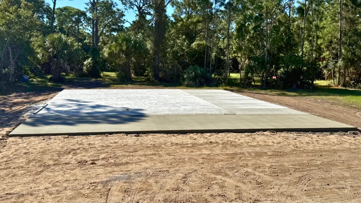Finished commercial concrete slab foundation on a cleared Florida job site