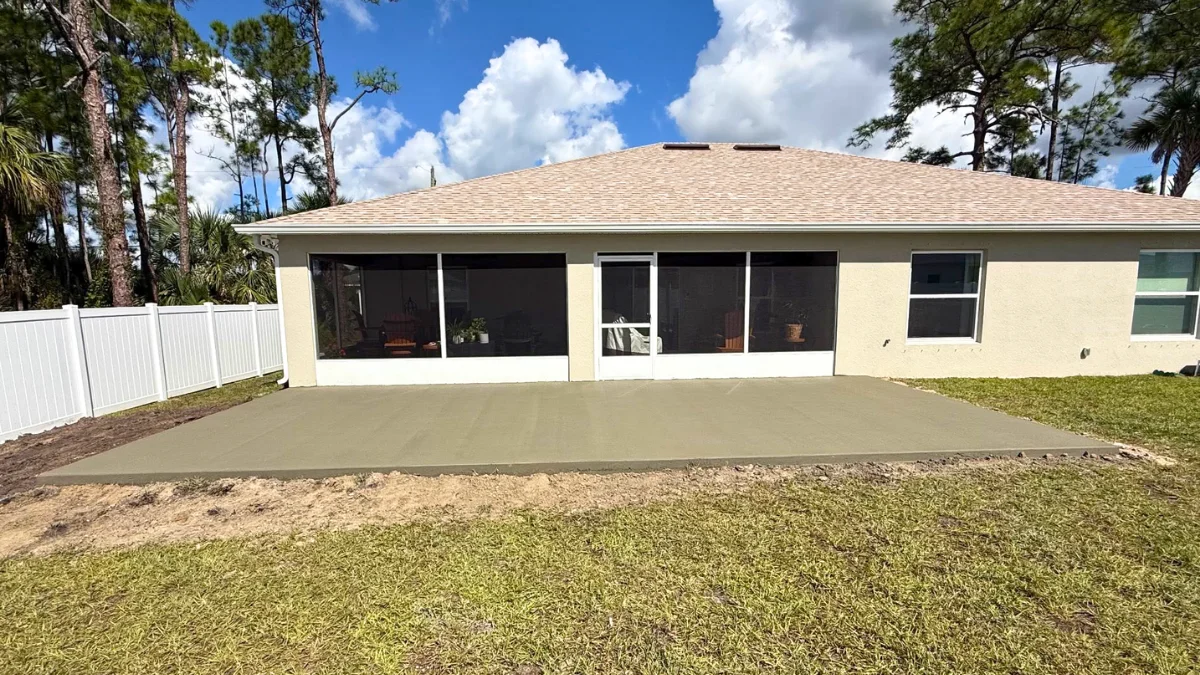 New backyard concrete patio poured behind a Florida home