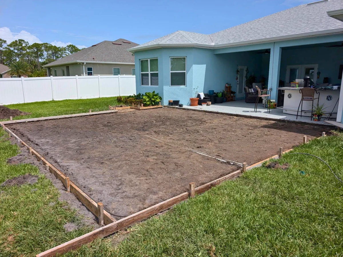 Backyard patio construction in progress, showing a 10x20 concrete patio.