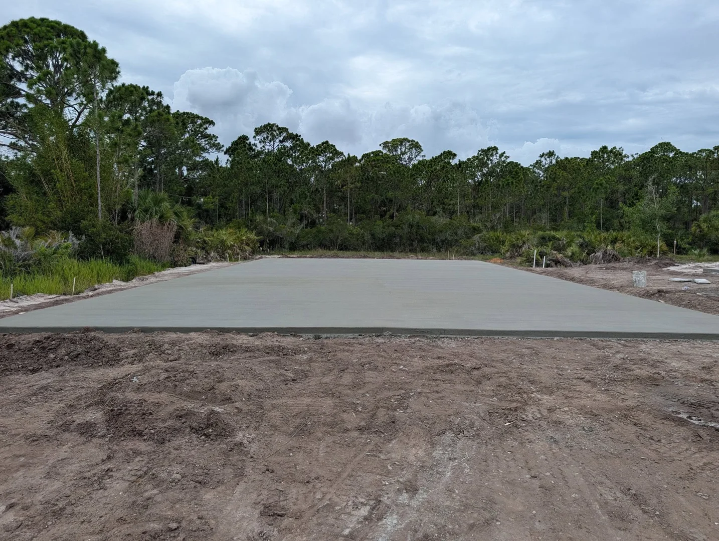 Finished concrete slab at a wooded project site