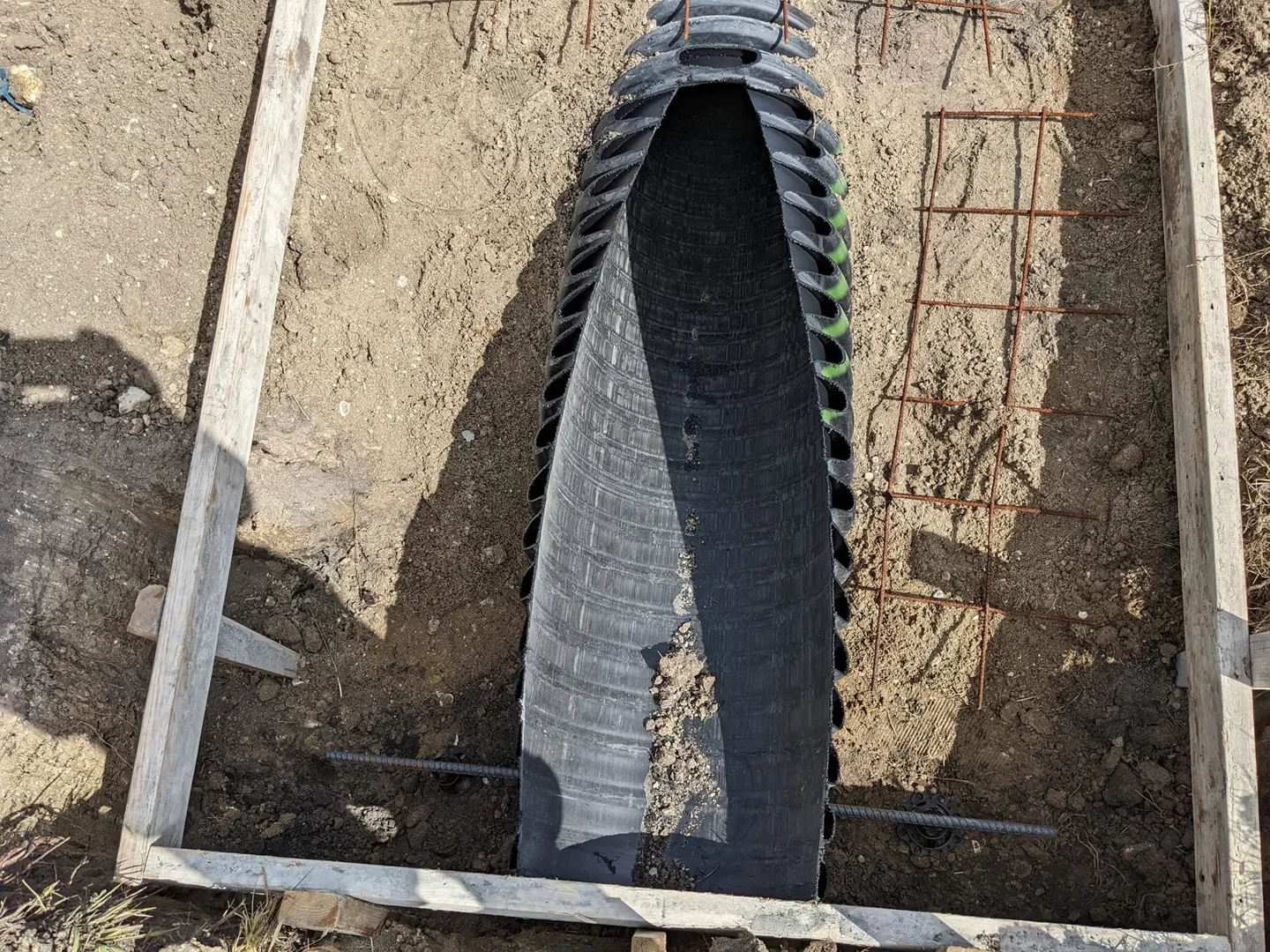 Culvert pipe with concrete forms and reinforcement during drainage preparation Culvert pipe with concrete forms and reinforcement during drainage preparation