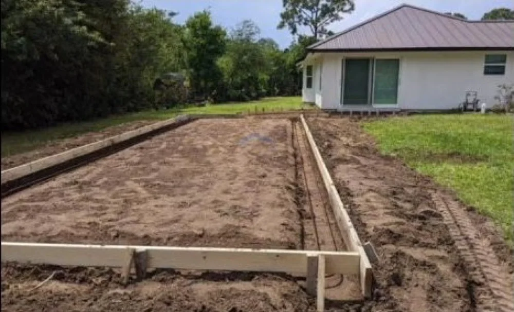 Formed outdoor concrete area beside a residence before placement Formed outdoor concrete area beside a residence before placement