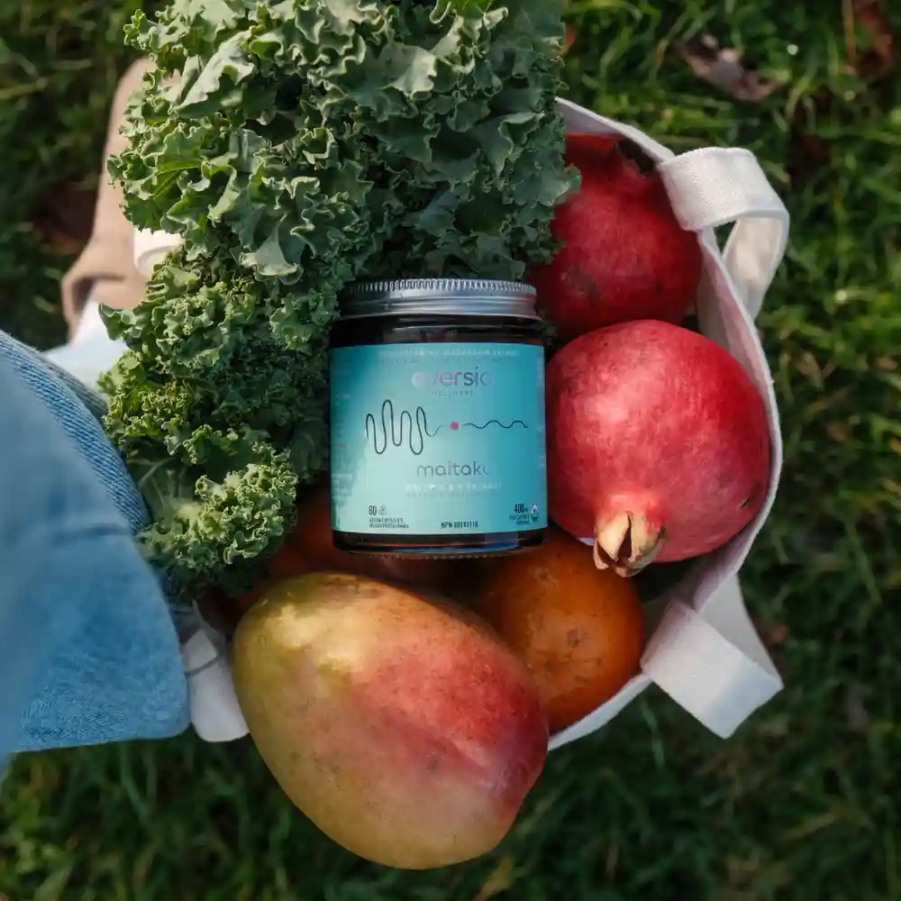 A basket of kale, pomegranates, and mangoes with Maitake extract, showing how to include hen of the wood mushroom benefits in a healthy diet. A basket of kale, pomegranates, and mangoes with Maitake extract, showing how to include hen of the wood mushroom benefits in a healthy diet.