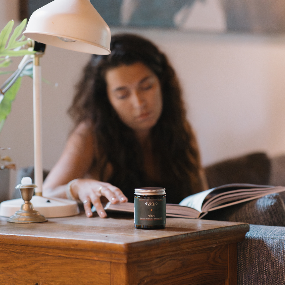 A jar of Reishi 15:1 dual extract on a nightstand, showcasing a relaxing way to end a mushroom daily dose routine.