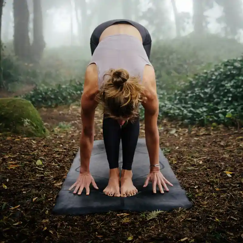 A person meditating peacefully in a natural setting - Reishi mushroom capsules