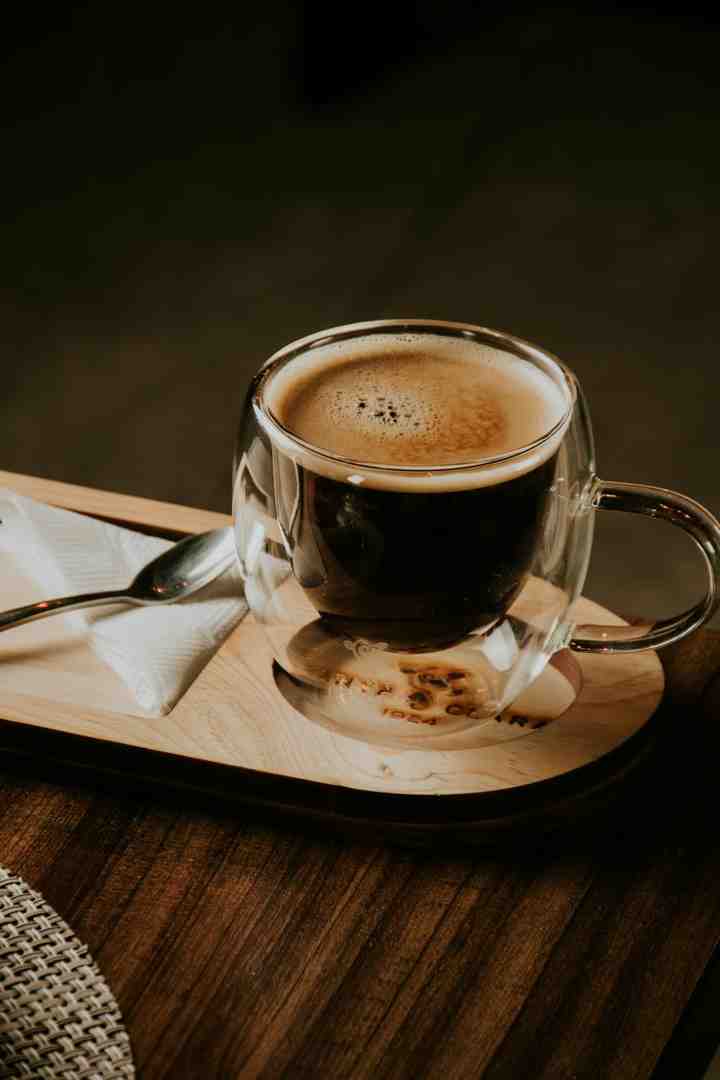 A selection of coffee beans displayed on a wooden surface, showcasing a variety of roast levels and bean types - best affordable coffee beans