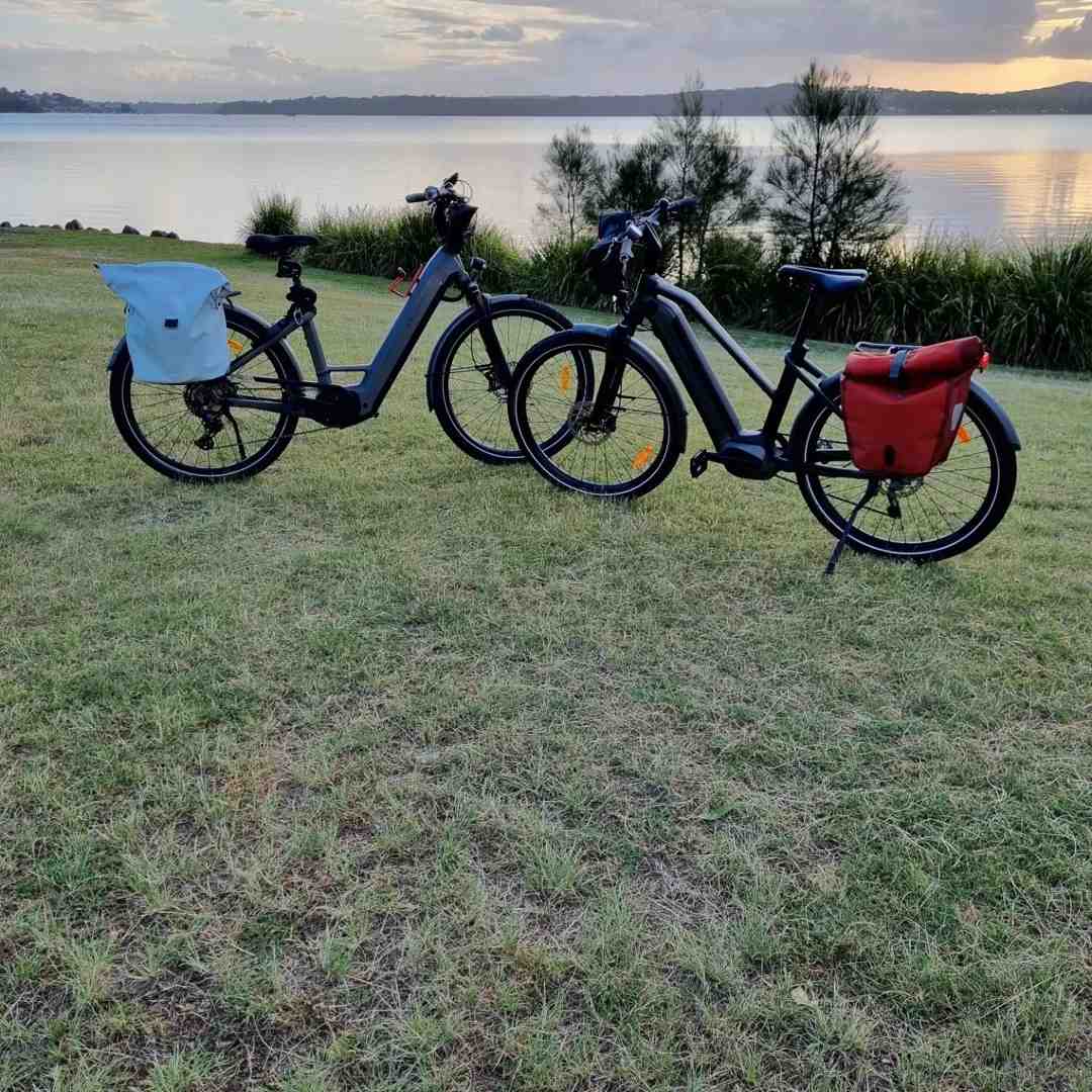 diverse group of people on e-bikes and trikes smiling on a scenic, paved rail trail in Brisbane - tips for beginners using rail trails
