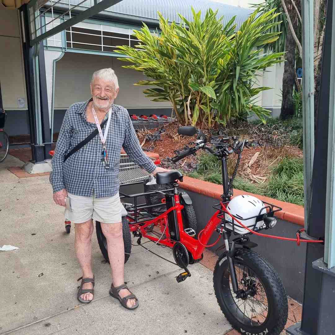 person easily riding an e-trike up a gentle slope - senior mobility solutions