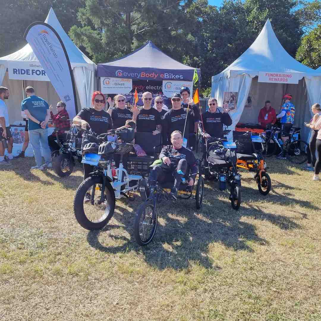 Joyful diverse group riding adaptive trike - adaptive trike