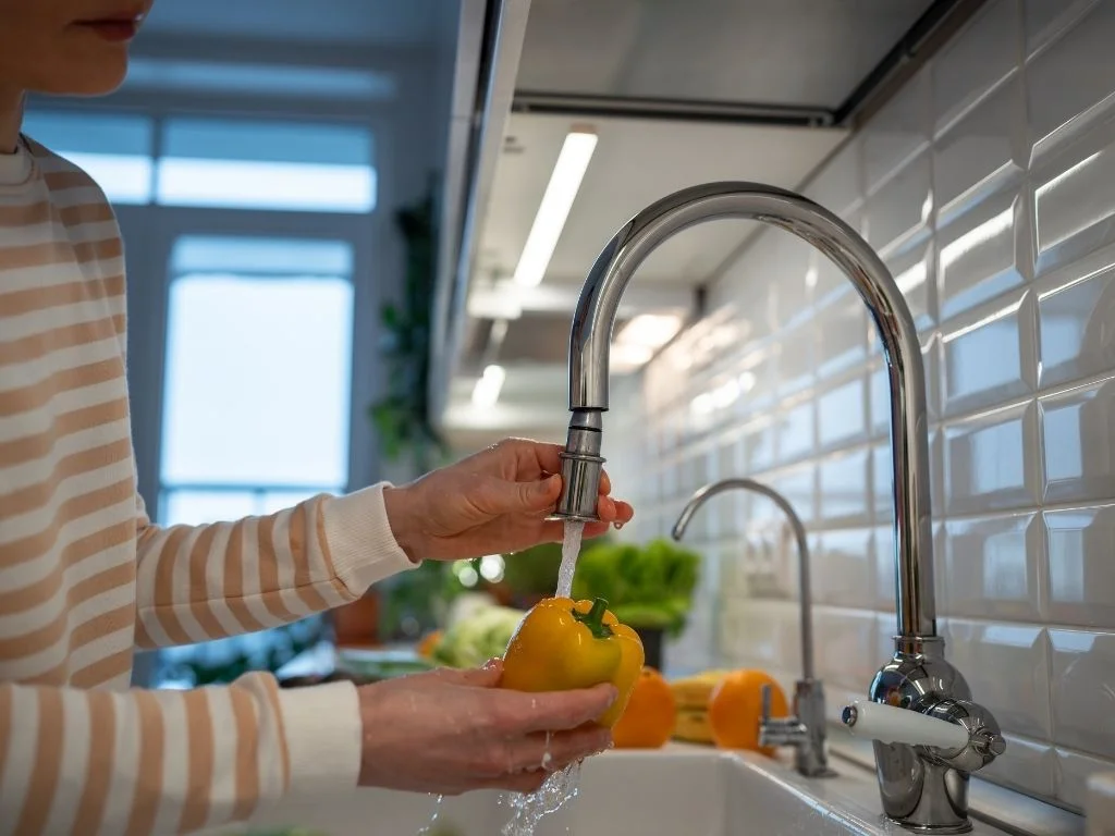 Homeowner using the newly installed kitchen faucet in Largo, FL