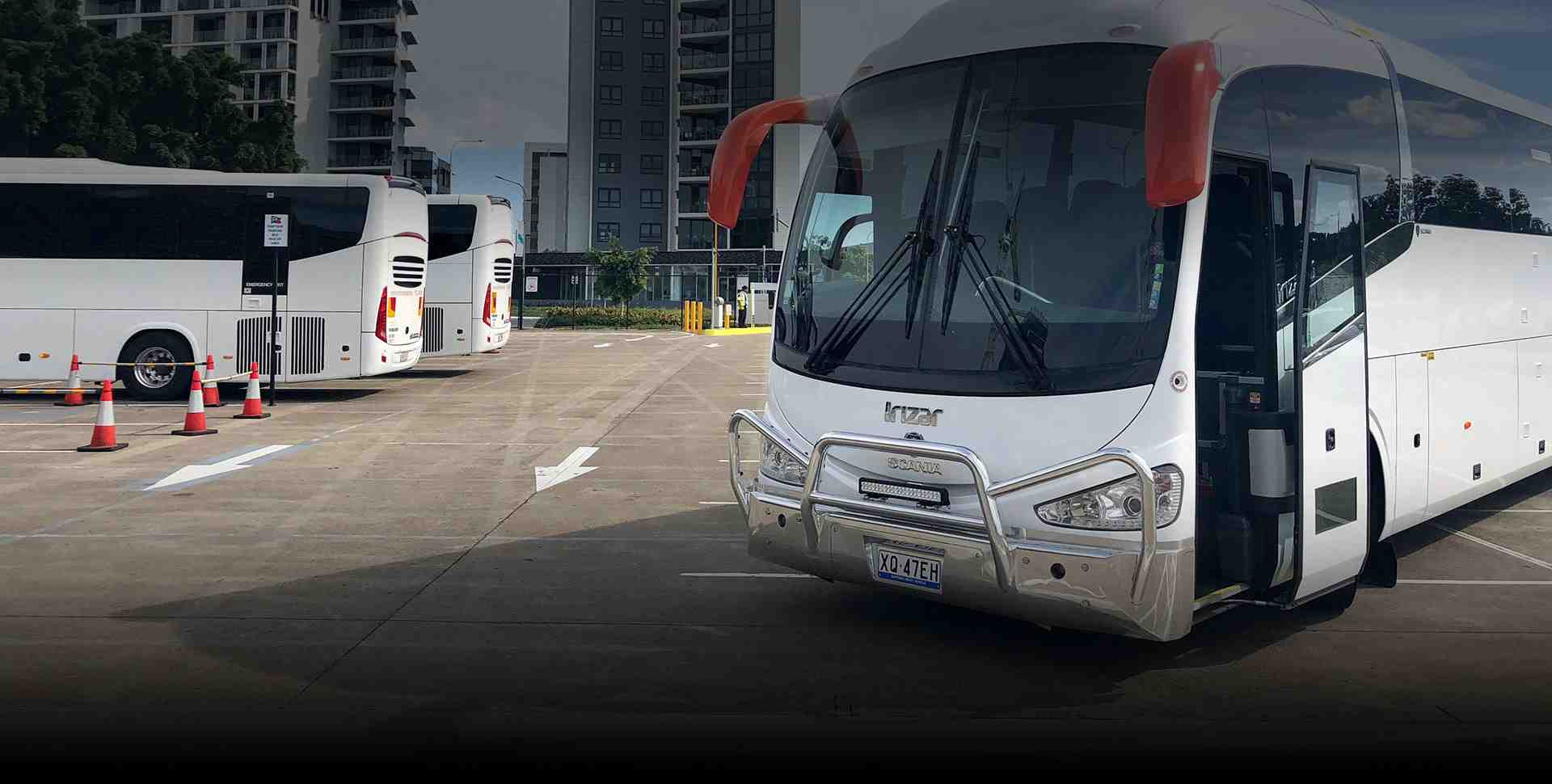 Header photo of a modern coach on a scenic Gold Coast road. - bus hire Gold Coast