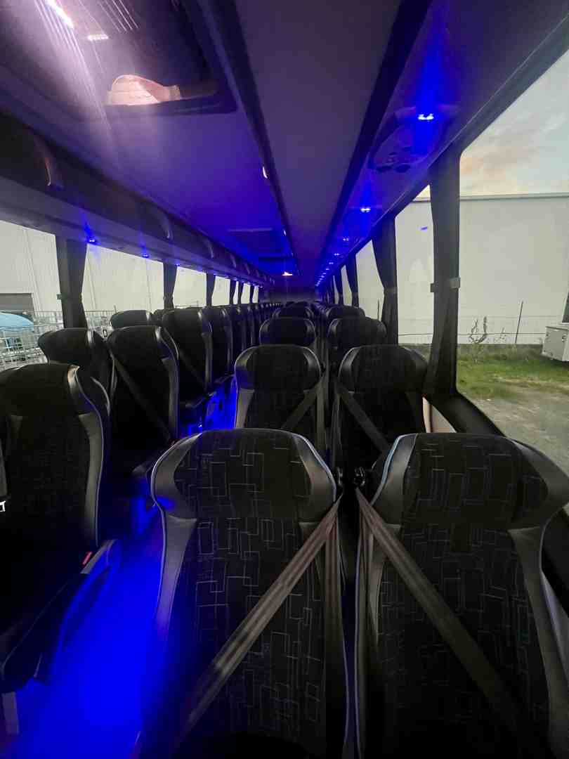 Interior of a luxury coach showing spacious seating and amenities - sports team bus rental 