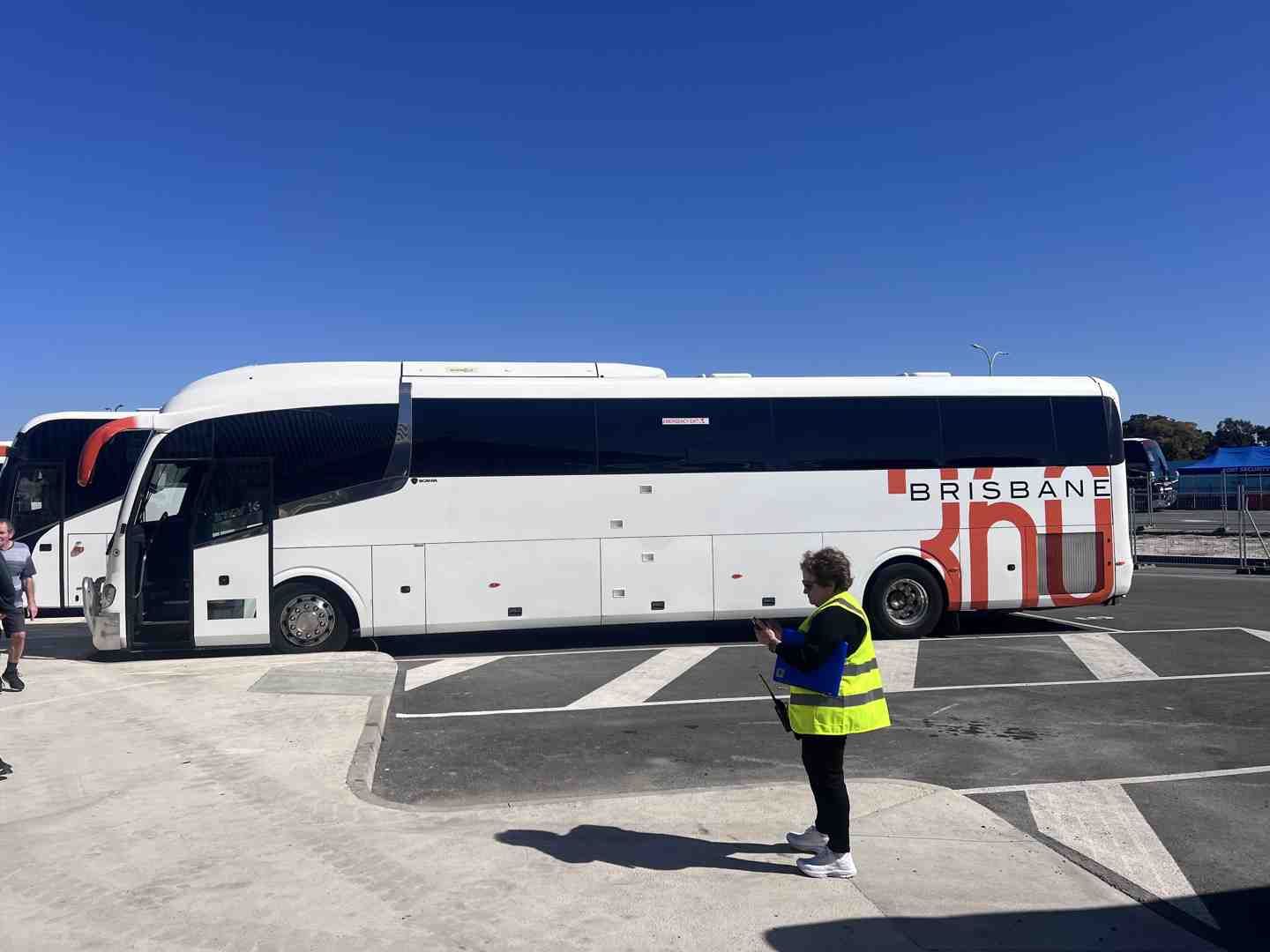 Employees boarding a modern passenger coach for business transport.