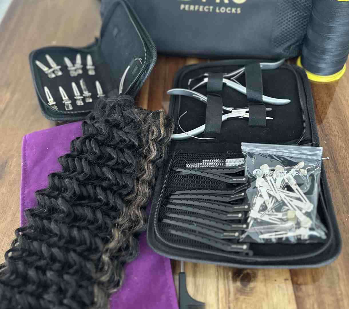 stylist carefully sewing hand-tied wefts onto beaded foundation - curly hand tied extensions
