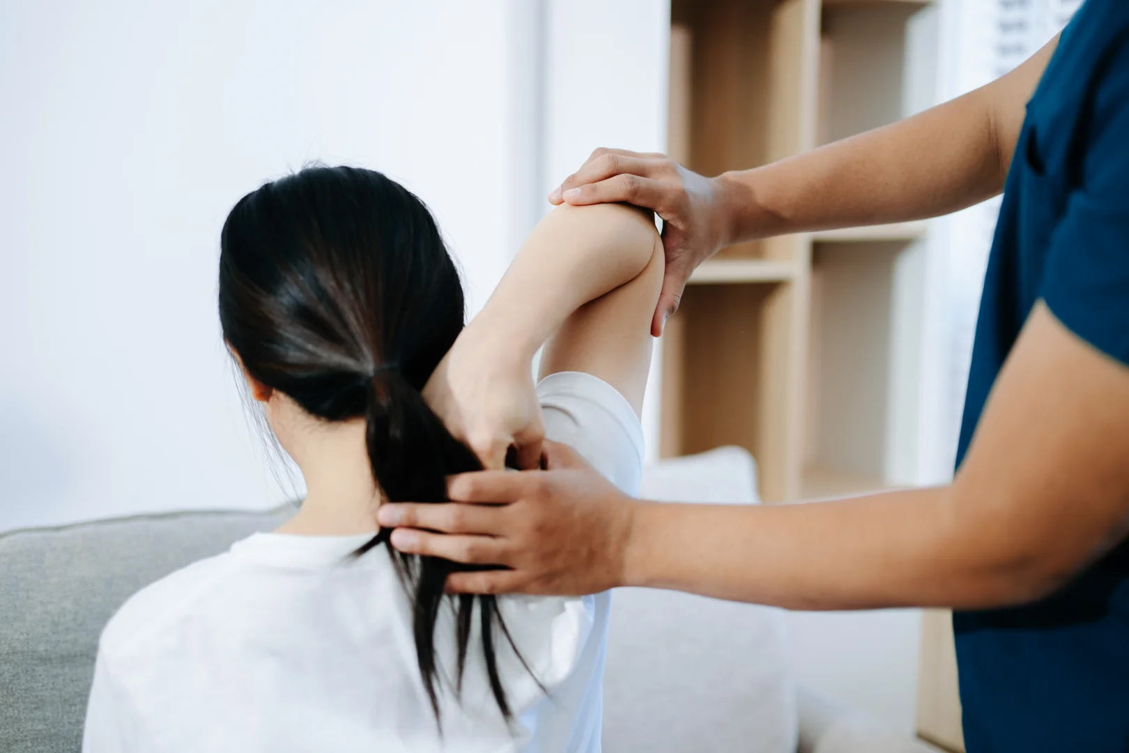 Patient in a North Tampa clinic discussing neck pain symptoms with a chiropractor - whiplash treatment tampa