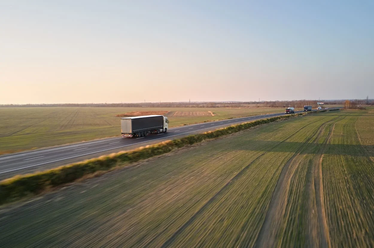 aerial view of semi truck with cargo trailer driving in indiana