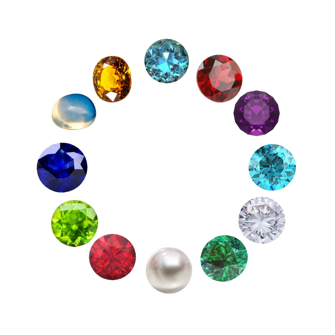 Loose birthstones in a circular design on an isolated white background, including garnet, amethyst, aquamarine, diamond, emerald, pearl, ruby, peridot, blue sapphire, opal, citrine, & blue topaz.