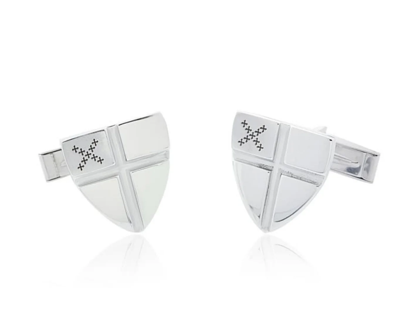 A pair of custom-designed white gold men's cufflinks in a family crest design.